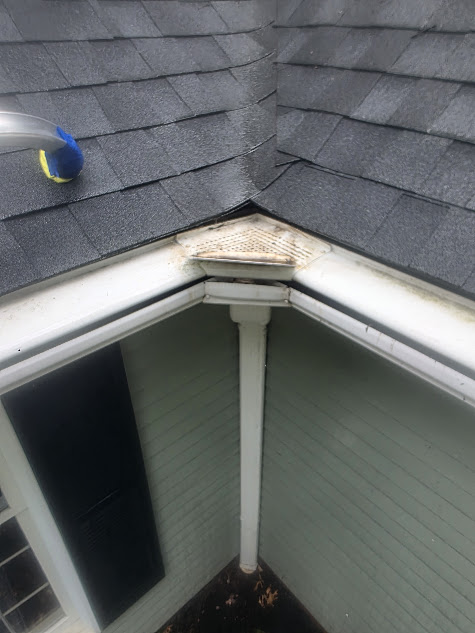 Clean roof section and gutter line after maintenance