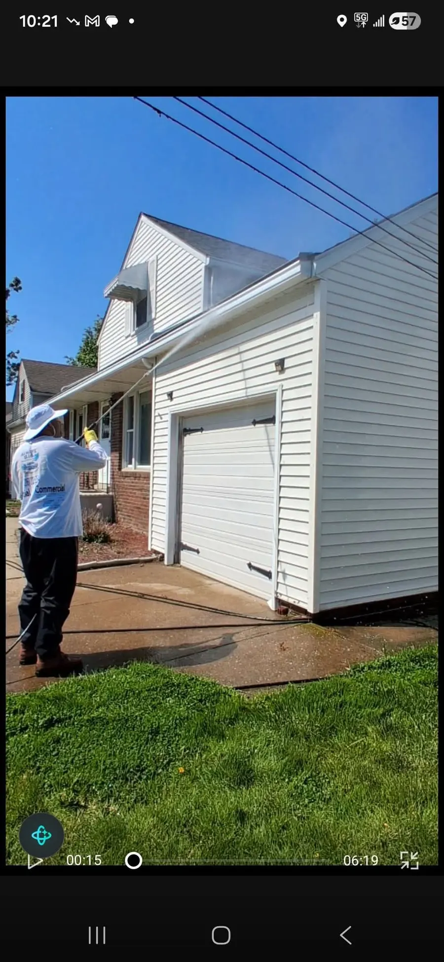 Owner Michael Betts soft washing a home's siding